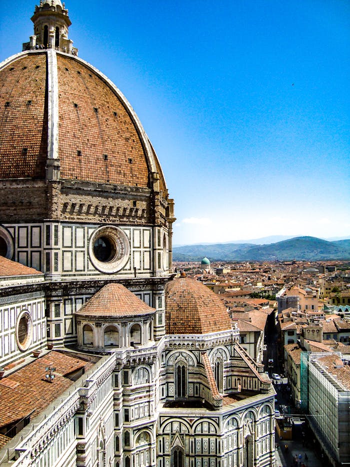 engagement-photography-03 Iconic view of Florence Cathedrals dome against a clear Tuscan sky, a masterpiece of Renaissance architecture.